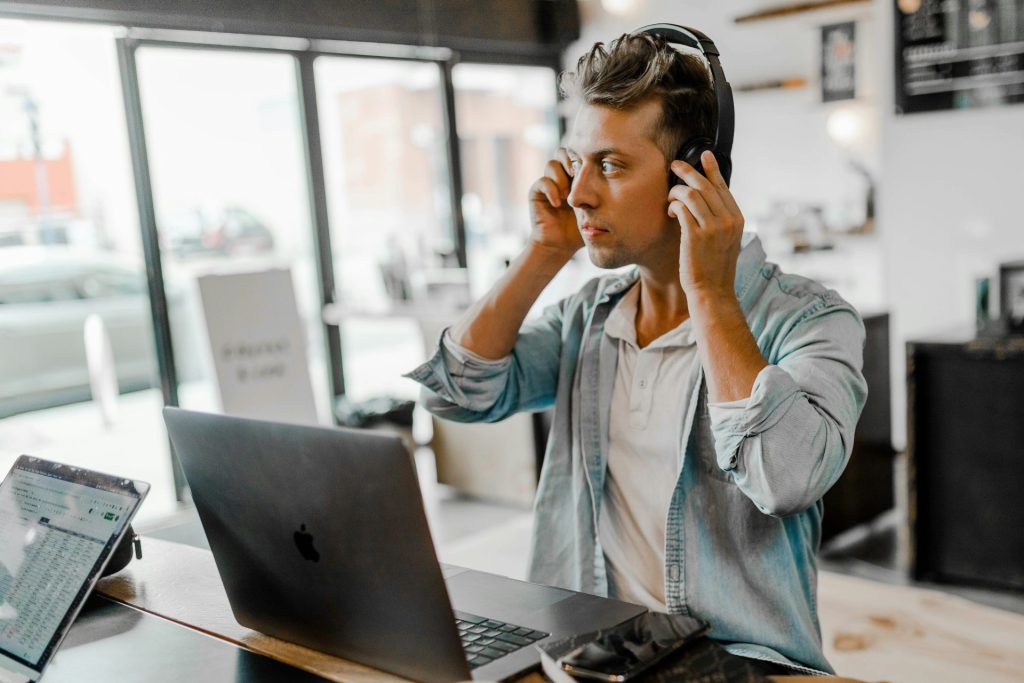 Man with headphones working on laptop